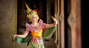 Portrait of Thailand dancer in Kinnaree costume dancing against the temple wall